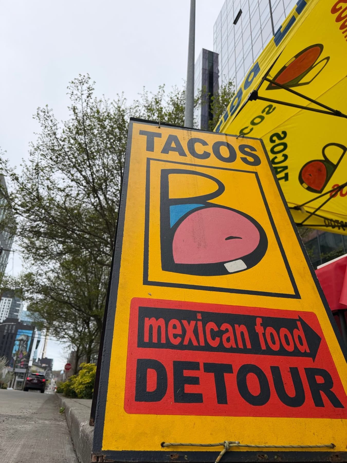 The colorful Barriga Llena TACOS and Mexican food detour street sign