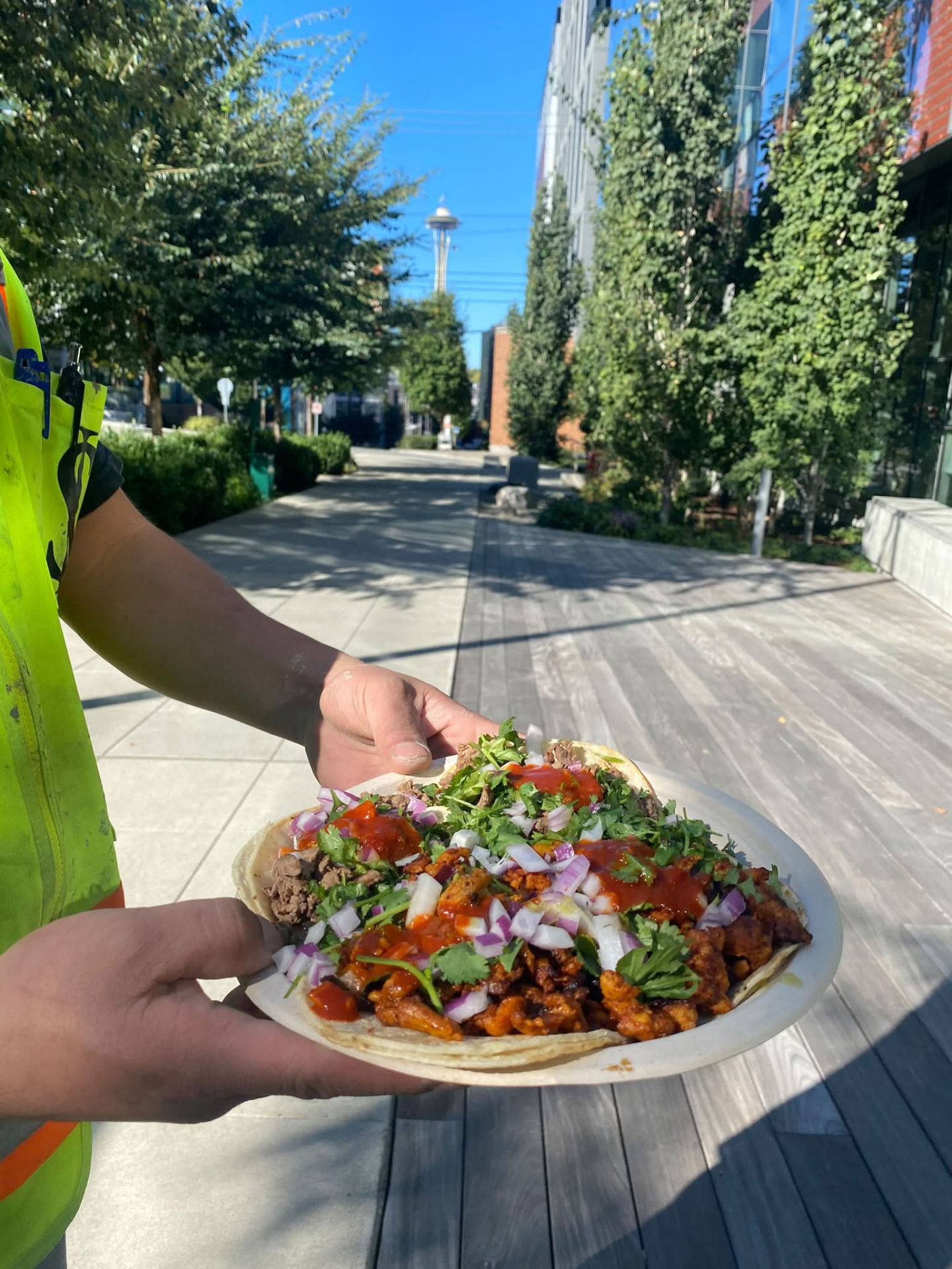 A plate of freshly made street tacos held up in South Lake Union